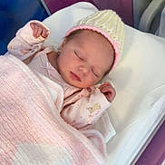Lily-Mae is registered to the contest to win money with this photo: newborn, baby, sleeping, blanket, hat, hospital, bassinet, infant, pink, cozy, cute, child, resting, soft, clothing, bed, person, portrait, indoors, peaceful