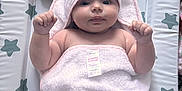 Lily-Mae is registered to the contest to win money with this photo: baby, infant, towel, hooded_towel, changing_mat, star_pattern, pacifier, pink, soft_texture, cute, child, newborn, lying_down, raised_fists, indoor, face, skin, expression, blanket, comfort