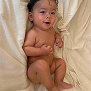 Adonis joined the competition — help win amazing prizes! baby, barefoot, bed, bedding, blanket, child, cozy, cream_color, curly_hair, face, hands, indoors, infant, legs, lying_down, photography, portrait, sitting, skin, smiling