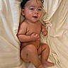 baby, barefoot, bed, bedding, blanket, child, cozy, cream_color, curly_hair, face, hands, indoors, infant, legs, lying_down, photography, portrait, sitting, skin, smiling
