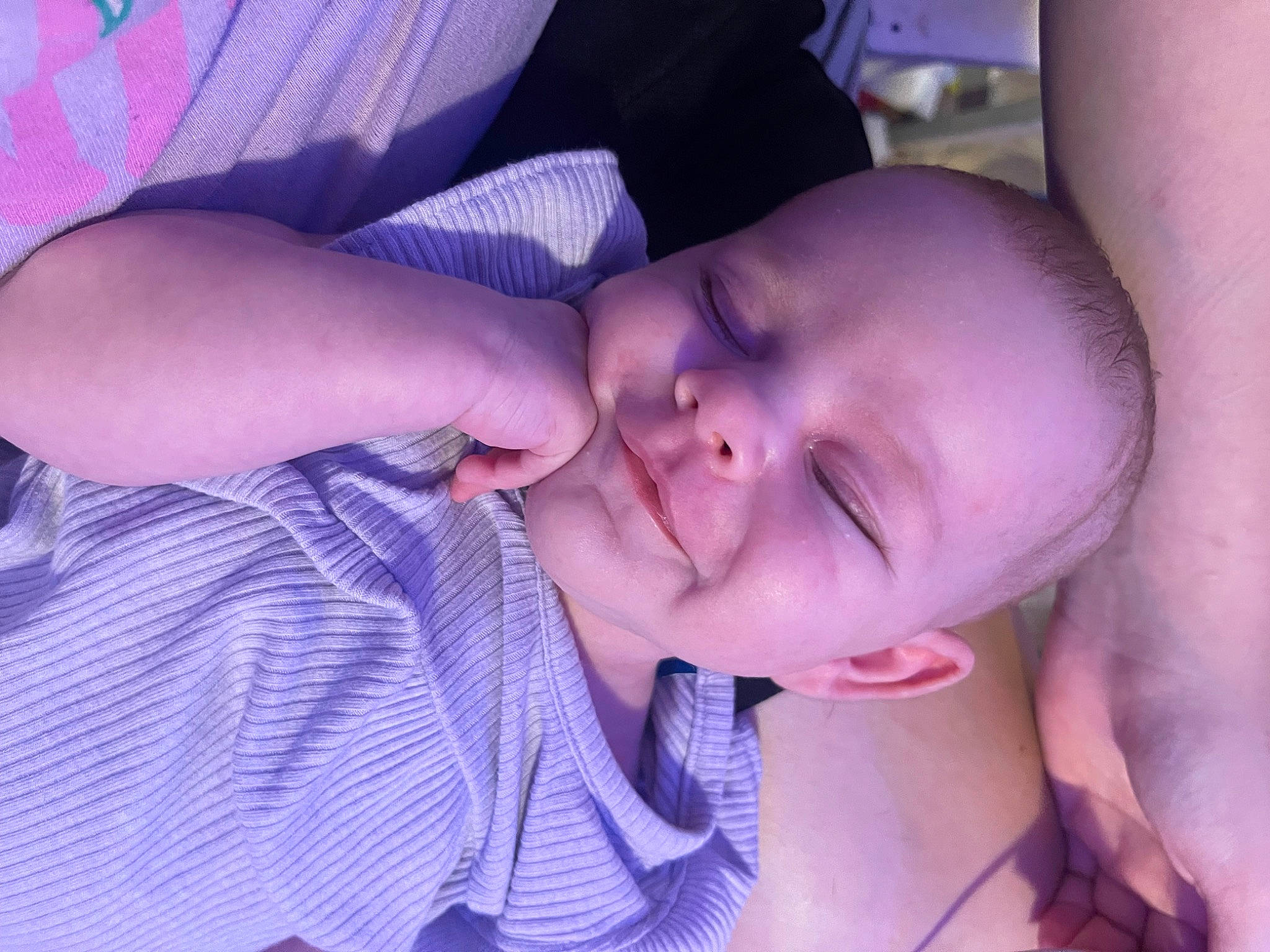 Aubrey is registered to the contest to win money with this photo: baby, baby_toddler_clothing, cheek, comfort, ear, eyelash, finger, gesture, hand, happy, iris, lip, mouth, nail, nose, person, purple, skin, smile, thumb