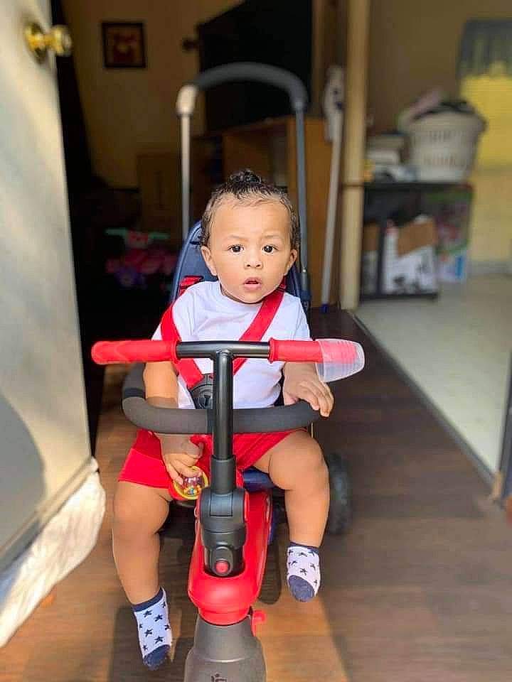 Royce joined the competition — help win amazing prizes! baby, baby_toddler_clothing, chair, child, curtain, floor, flooring, fun, human_leg, joint, knee, lap, leg, person, riding_toy, shorts, sneakers, sock, thigh, toddler