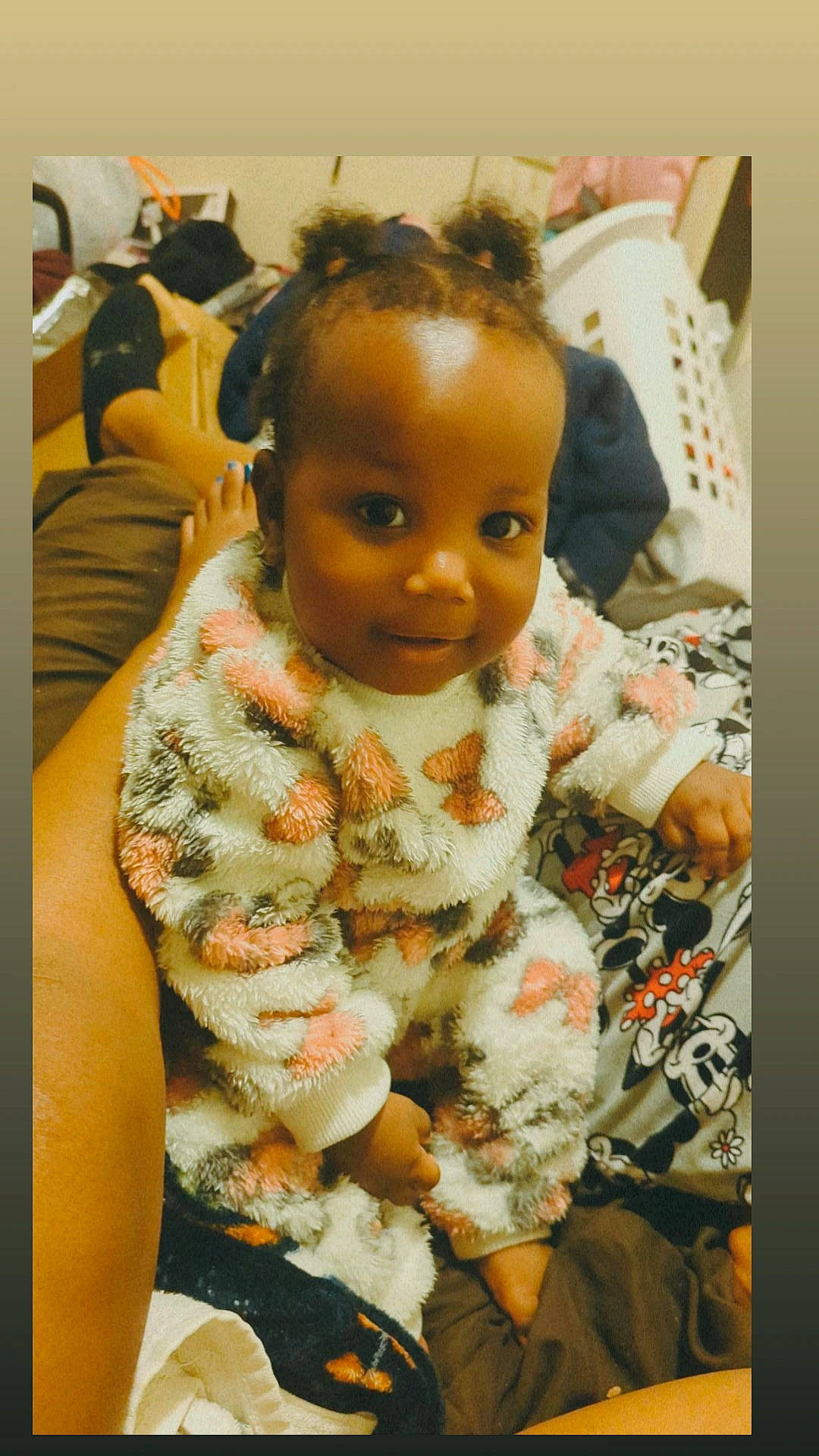 Delilah is registered to the contest to win money with this photo: baby, baby_toddler_clothing, cheek, child, comfort, eye, eyelash, hair, happy, linens, military_camouflage, nose, pattern, person, room, sitting, sleeve, smile, textile, toddler