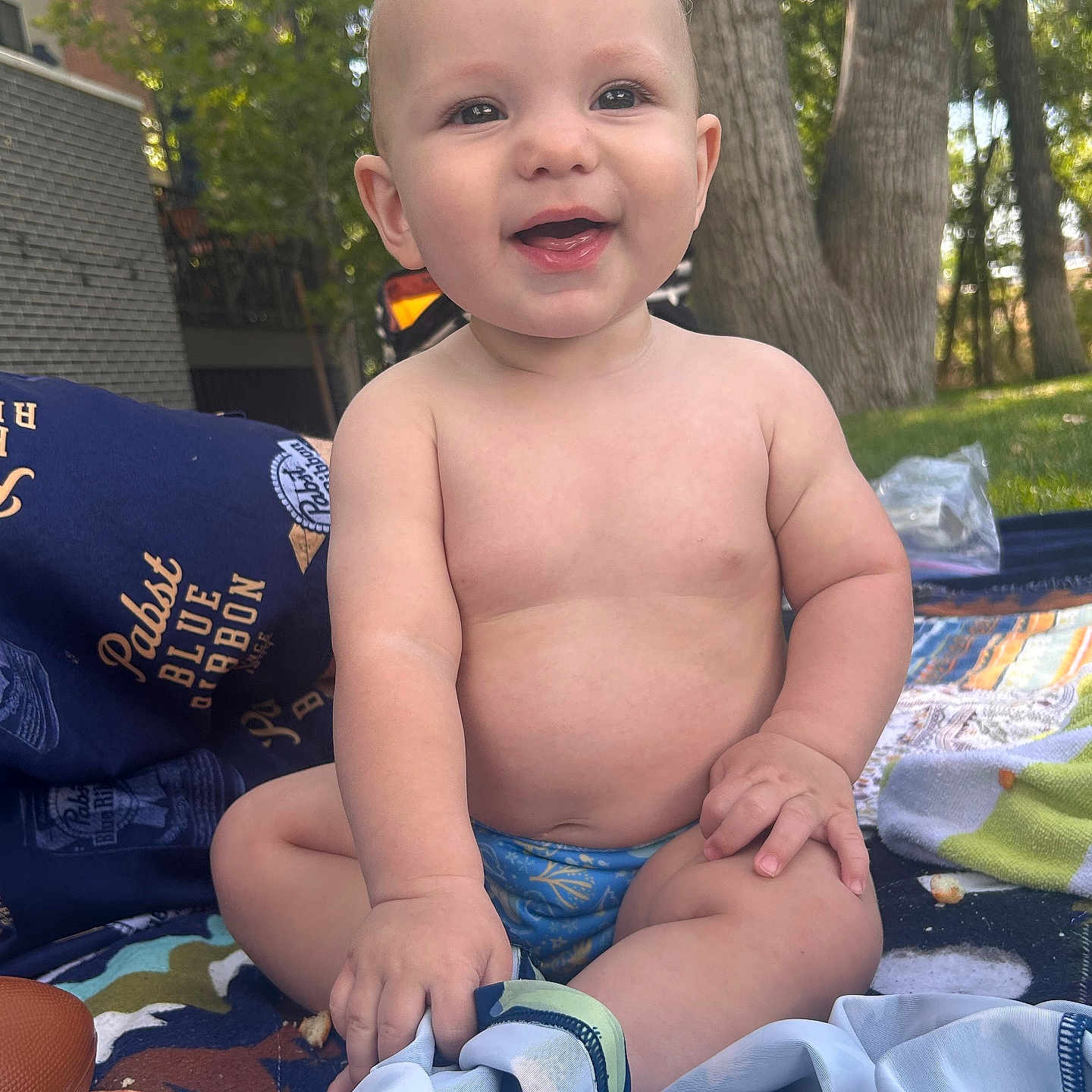Bentlee Barron joined the competition — help win amazing prizes! baby, smiling, outdoor, blanket, trees, grass, sunlight, child, happy, nature, toddler, cute, sitting, clothing, face, skin, daylight, playtime, summer, park