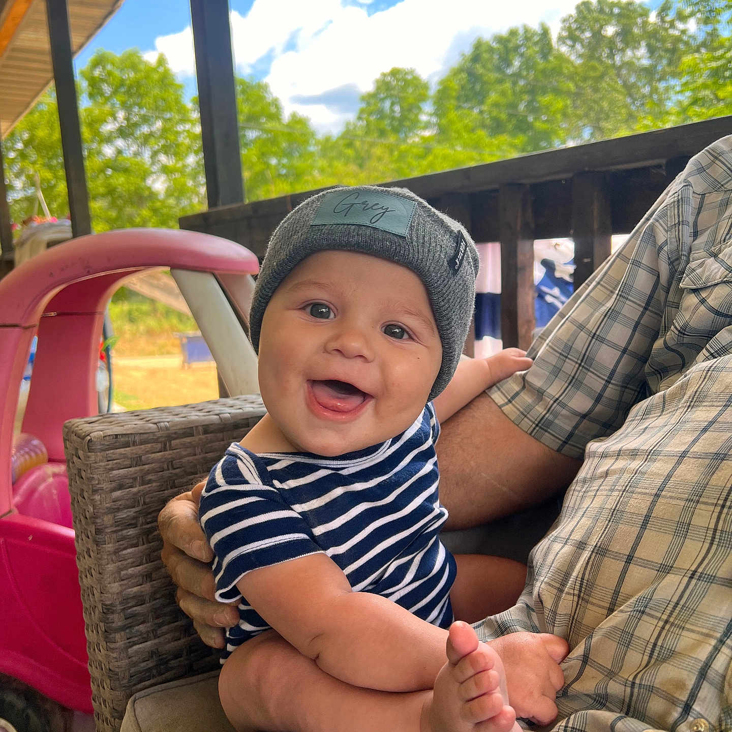 Grey is registered to the contest to win money with this photo: adult, baby, baseballcap, bodypart, cap, clothing, face, finger, hand, happy, hat, head, male, man, outdoors, pants, person, photography, portrait, smile