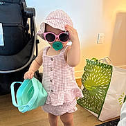 Addelina joined the competition — help win amazing prizes! toddler, child, sunglasses, hat, pink, indoor, bucket, toy, stroller, shopping_bag, floor, wooden_floor, clothing, barefoot, cute, playful, person, young_child, accessory, casual