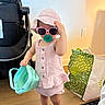 toddler, child, sunglasses, hat, pink, indoor, bucket, toy, stroller, shopping_bag, floor, wooden_floor, clothing, barefoot, cute, playful, person, young_child, accessory, casual