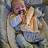 baby, baby_boy, baby_girl, baby_rocker, blanket, child, clothing, comfort, cushion, cute, footwear, homedecor, indoor, infant, pacifier, person, relaxed, seated, sleepwear, soft_toy