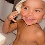 baby_teeth, bare_chest, cabinet, child, cute, expression, face, hand, happy, hat, headwear, home, indoor, person, playful, skin, smiling, tile_floor, toddler, young_child