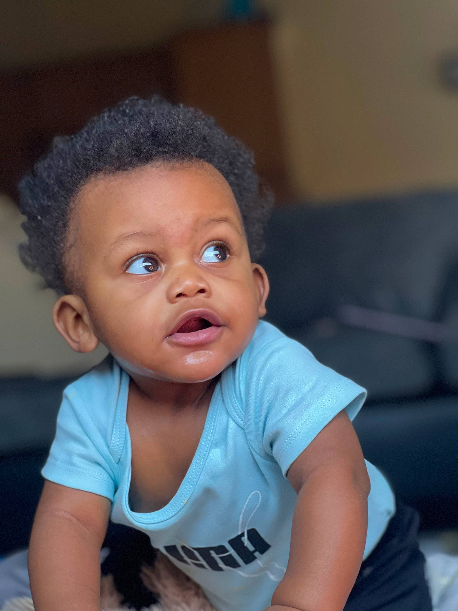 Junior is registered to the contest to win money with this photo: afro, baby_toddler_clothing, black_hair, cheek, chin, ear, eye, eyebrow, eyelash, flash_photography, forehead, gesture, happy, head, lip, nose, person, skin, sleeve, smile