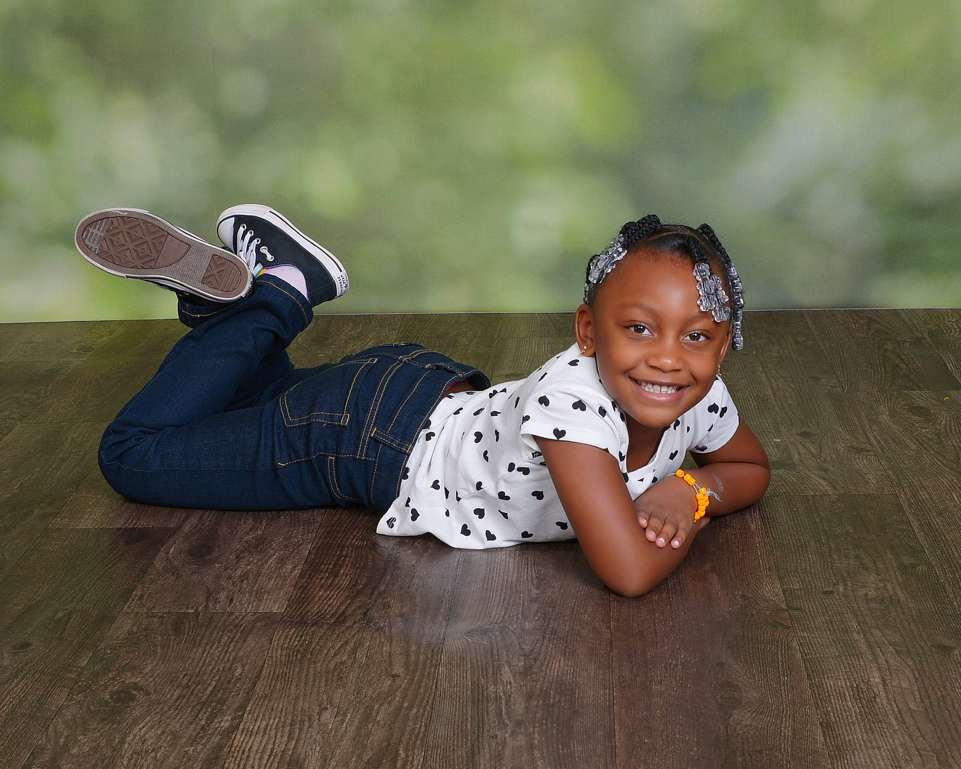 Emery is registered to the contest to win money with this photo: eyewear, fashion_accessory, flash_photography, floor, flooring, foot, grass, happy, hardwood, human_leg, joy, knee, leisure, pattern, person, sitting, smile, thigh, toddler, waist