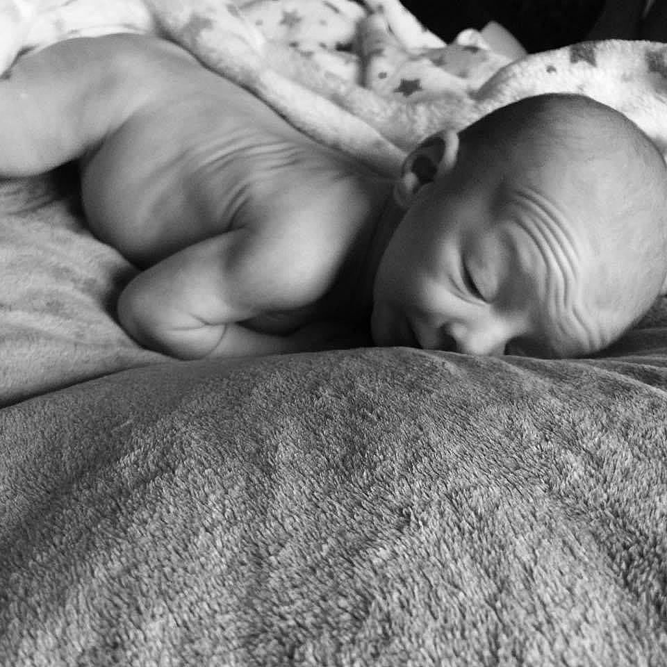 Jahziah is registered to the contest to win money with this photo: baby, bedtime, child, comfort, fur, gesture, grey, linens, monochrome, monochrome_photography, nap, person, photography, portrait_photography, room, skin, sleep, toddler