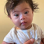 Ayan Raheem is registered to the contest to win money with this photo: baby, child, infant, face, hair, hand, white_shirt, curious_expression, portrait, human, skin, eyes, cute, indoor, person, young_child, holding, toddler, casual_clothing, neutral_background