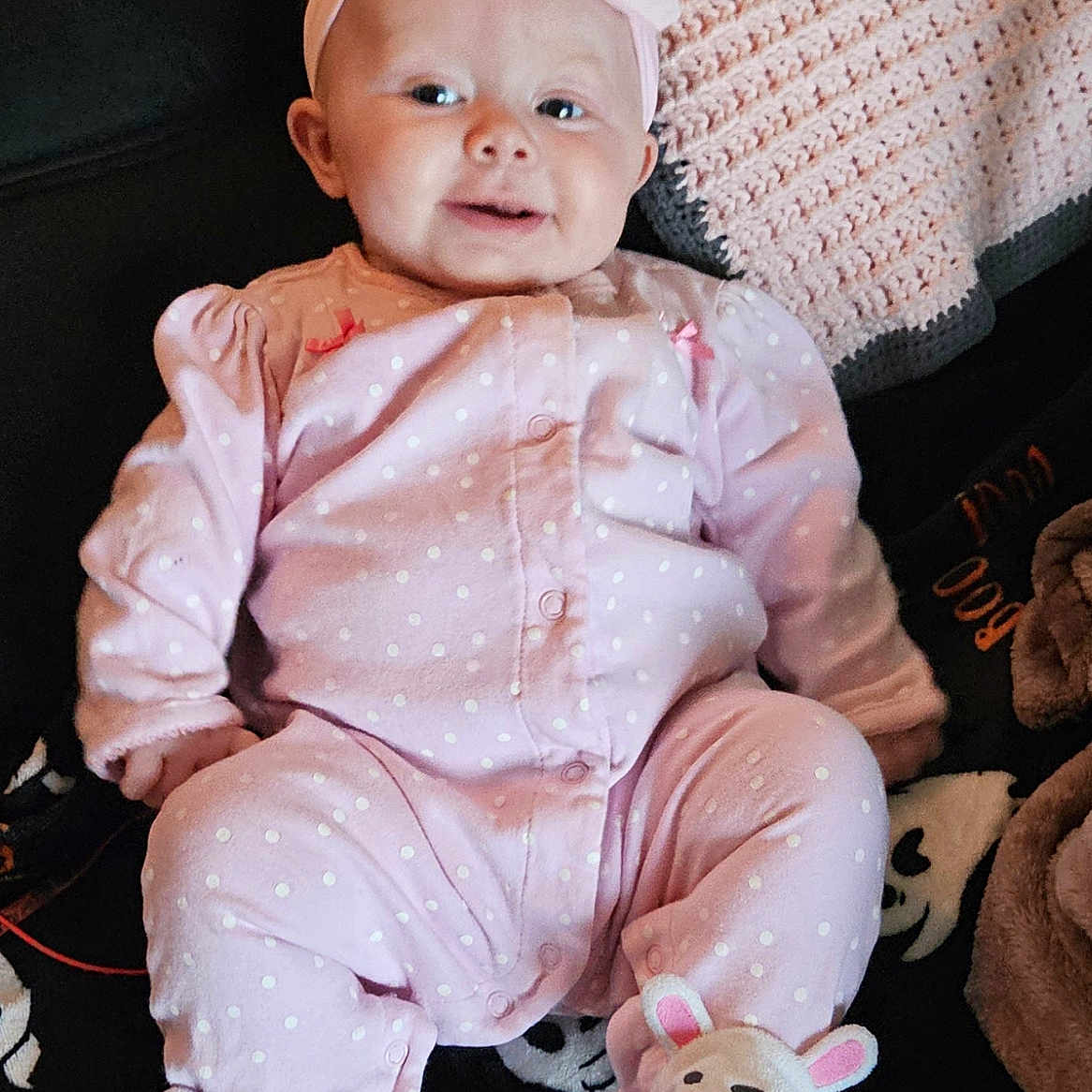 Lilly is registered to the contest to win money with this photo: baby, bodypart, cap, clothing, couch, cushion, face, finger, furniture, hand, hat, head, homedecor, pajamas, pants, person, photography, portrait, sitting, toy