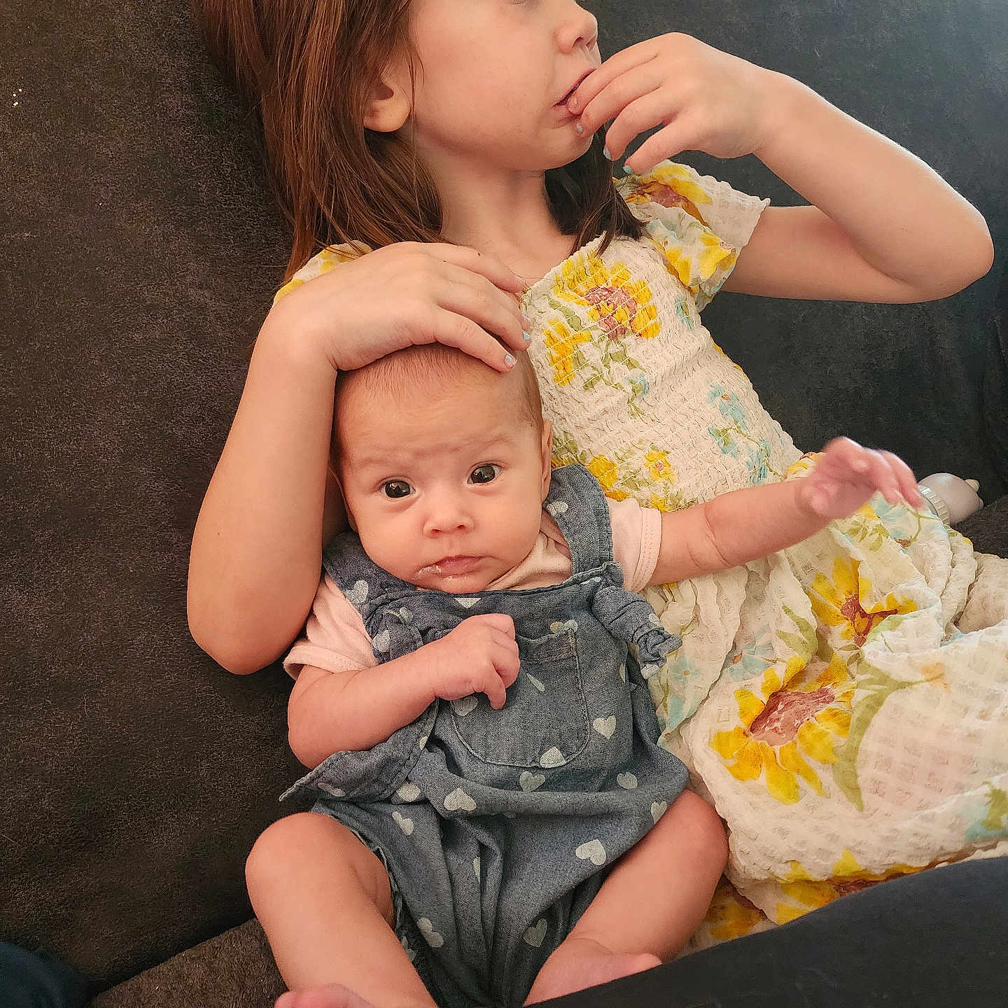 Ava joined the competition — help win amazing prizes! baby, bodypart, clothing, couch, cushion, dress, eating, face, finger, food, furniture, hand, head, homedecor, newborn, pants, person, photography, portrait, sitting