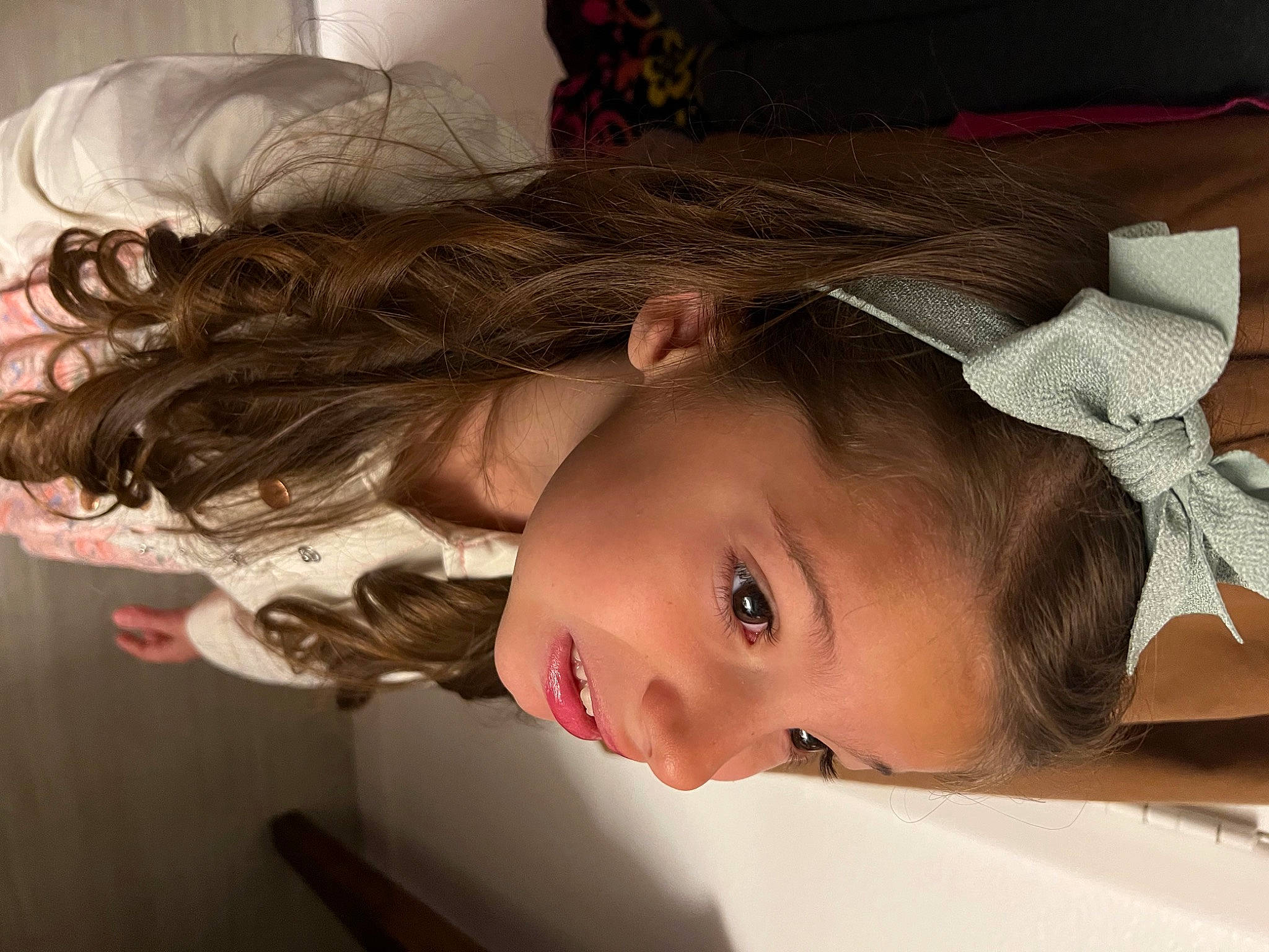 Starla is registered to the contest to win money with this photo: bridal_accessory, cheek, dress, ear, eye, eyelash, flash_photography, forehead, happy, headpiece, iris, lip, long_hair, neck, nose, person, shoulder, skin, smile, toddler