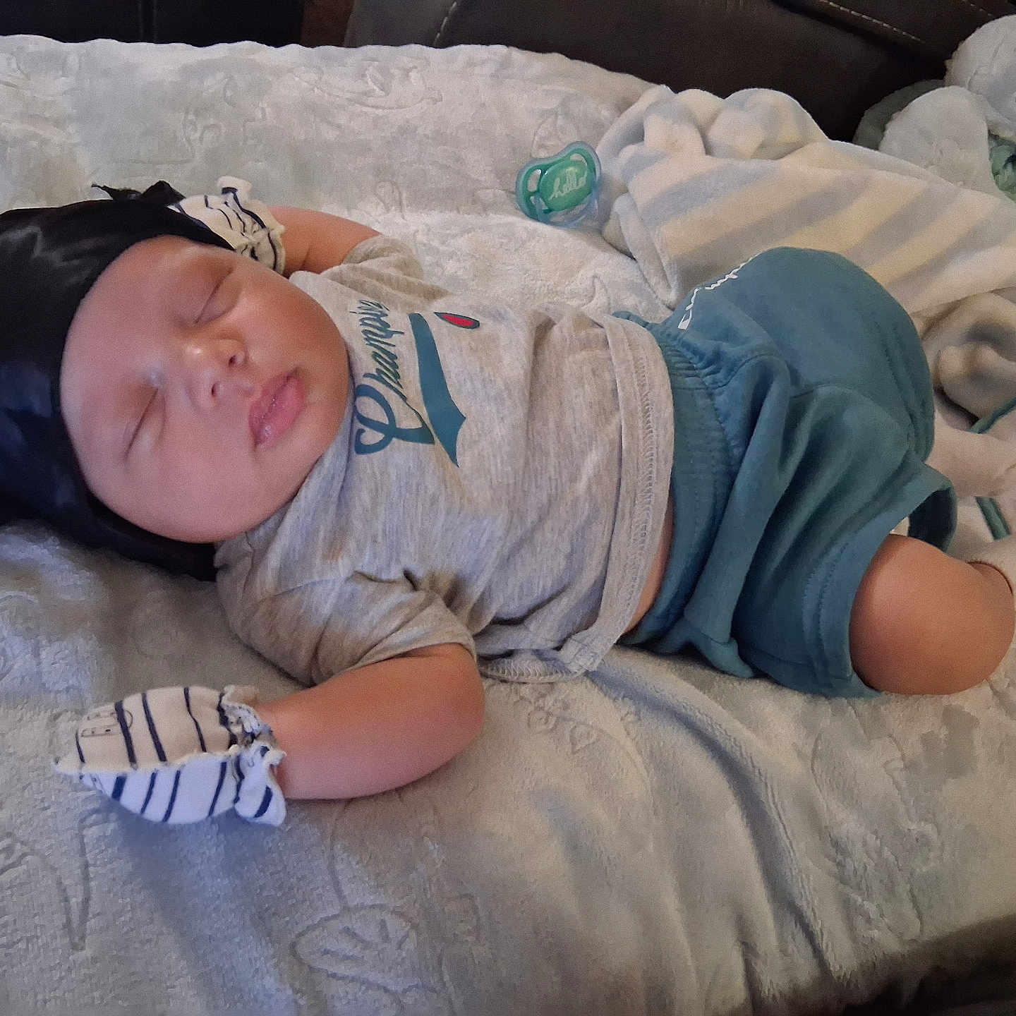 Dahveair is registered to the contest to win money with this photo: baby, bed, blanket, clothing, comfort, cute, face, headwrap, indoors, infant, mittens, nap, pacifier, peaceful, person, resting, skin, sleeping, soft, toddler