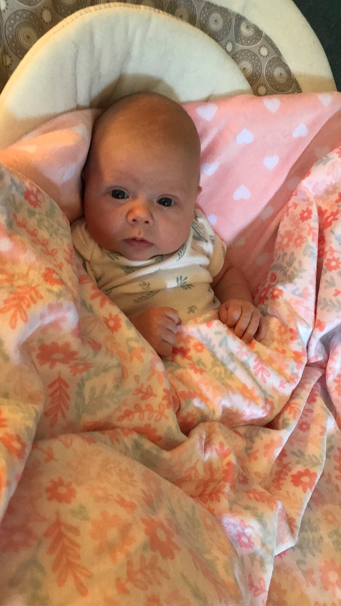 Brantley is registered to the contest to win money with this photo: baby, baby_products, baby_toddler_clothing, bedding, cheek, child, comfort, event, eye, face, head, iris, linens, lip, mouth, nose, person, pink, sitting, skin