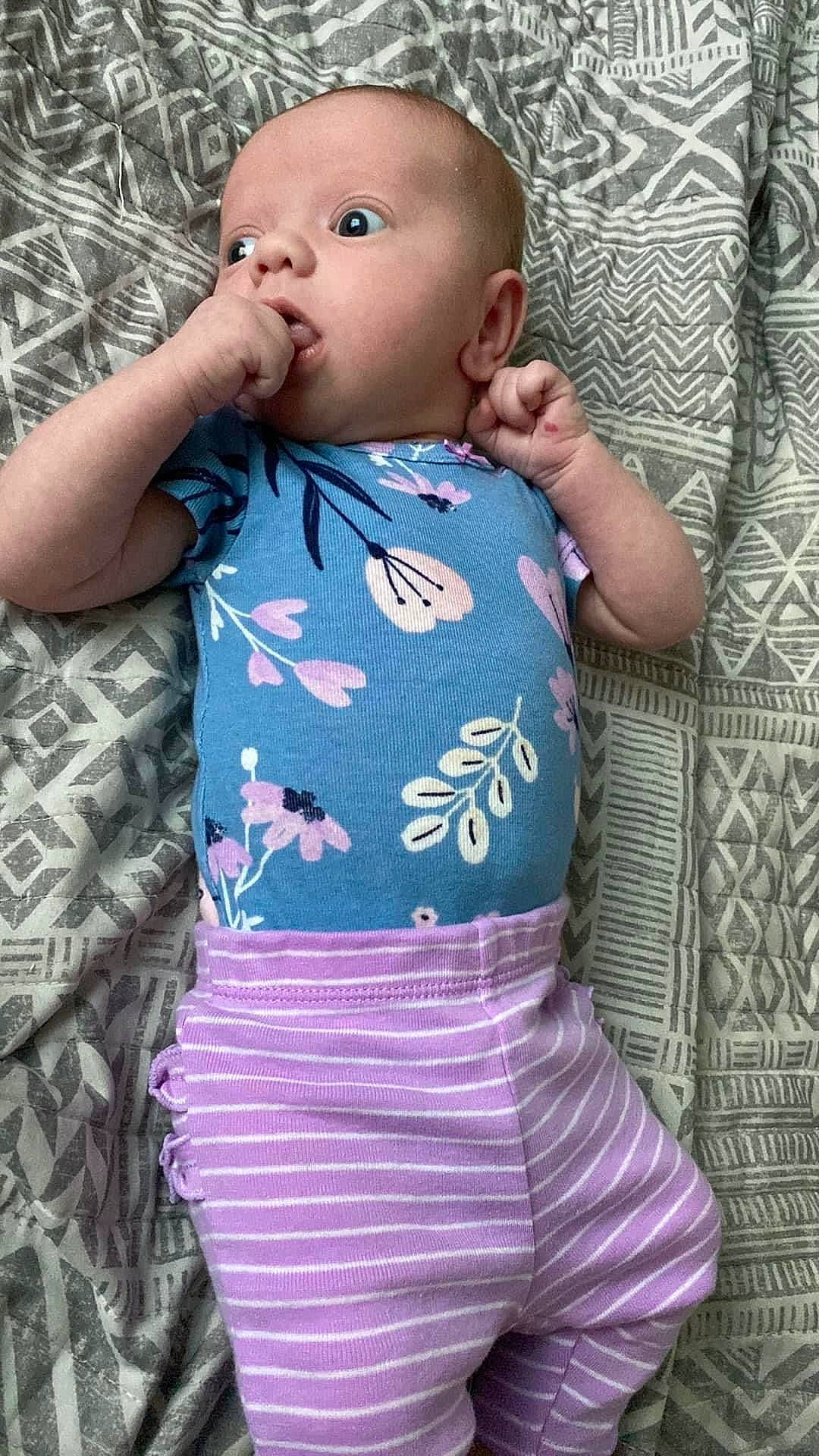 Madelyn is registered to the contest to win money with this photo: arm, baby, baby_toddler_clothing, cheek, dress, eye, face, hair, hairstyle, head, iris, lip, nose, person, pink, product, purple, skin, sleeve, standing