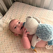Shawn joined the competition — help win amazing prizes! baby, infant, child, crib, mattress, blanket, stuffed_animal, teddy_bear, toy, blue_blanket, lying_down, face, eyes, smiling, indoors, nursery, crib_bars, patterned_bedding, pacifier_clip, portrait