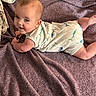 baby, child, infant, smiling, portrait, lying_down, blanket, purple_blanket, dinosaur_outfit, onesie, clothing, face, eyes, hands, legs, indoor, cozy, happy, candid, photography