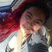 Angel joined the competition — help win amazing prizes! woman, selfie, dog, small_dog, car_interior, seatbelt, red_hair, smiling, casual_clothing, sunlight, shadow, pet, companion, closeup, portrait, relaxed, travel, transportation, grey_jacket, friendship