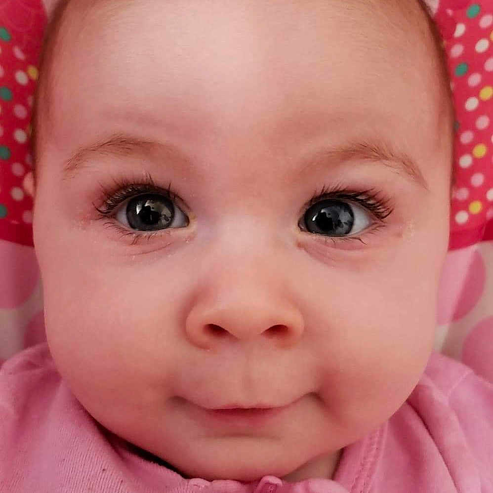 Katharine joined the competition — help win amazing prizes! baby, cheek, child, chin, close_up, eye, eyebrow, face, facial_expression, forehead, hair_accessory, head, headgear, iris, lip, mouth, nose, person, pink, skin