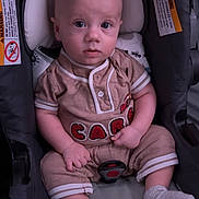 Aries joined the competition — help win amazing prizes! baby, infant, child, car_seat, sitting, portrait, face, wide_eyed, calm, onesie, romper, pink_clothing, socks, buckle, harness, indoor, close_up, carriage, safety_labels, photography