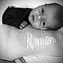 baby, newborn, pillow, knitted, embroidery, face, hand, sleeping, resting, black_and_white, portrait, infant, soft_texture, closeup, cute, cozy, blanket, child, young, peaceful