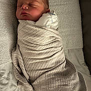 Roman is registered to the contest to win money with this photo: newborn, baby, sleeping, blanket, knitted, cozy, infant, bed, bedding, white, soft, peaceful, wrapped, portrait, child, cute, resting, indoors, closeup, face