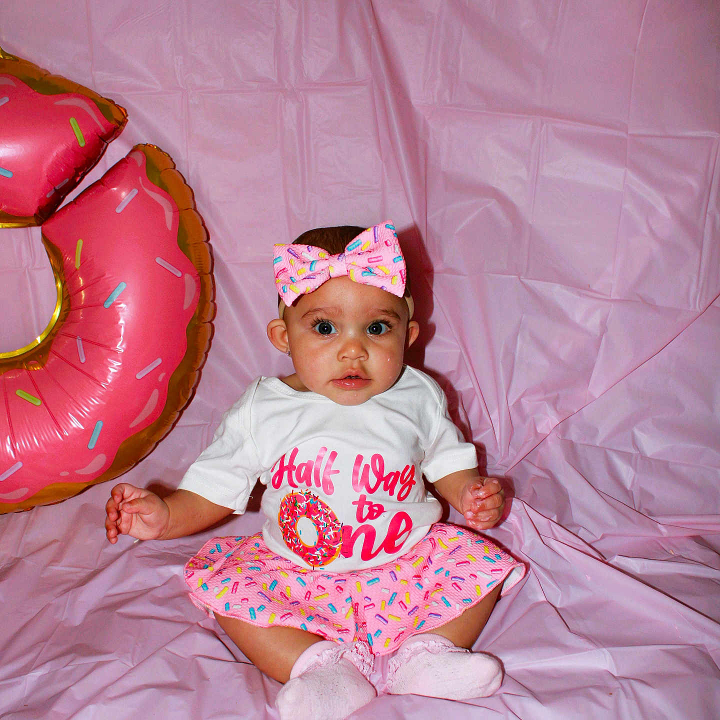 Janielle is registered to the contest to win money with this photo: baby, balloon, bodypart, bonnet, cap, clothing, couch, face, finger, food, furniture, hand, hat, head, inflatable, partyhat, person, photography, portrait, sweets