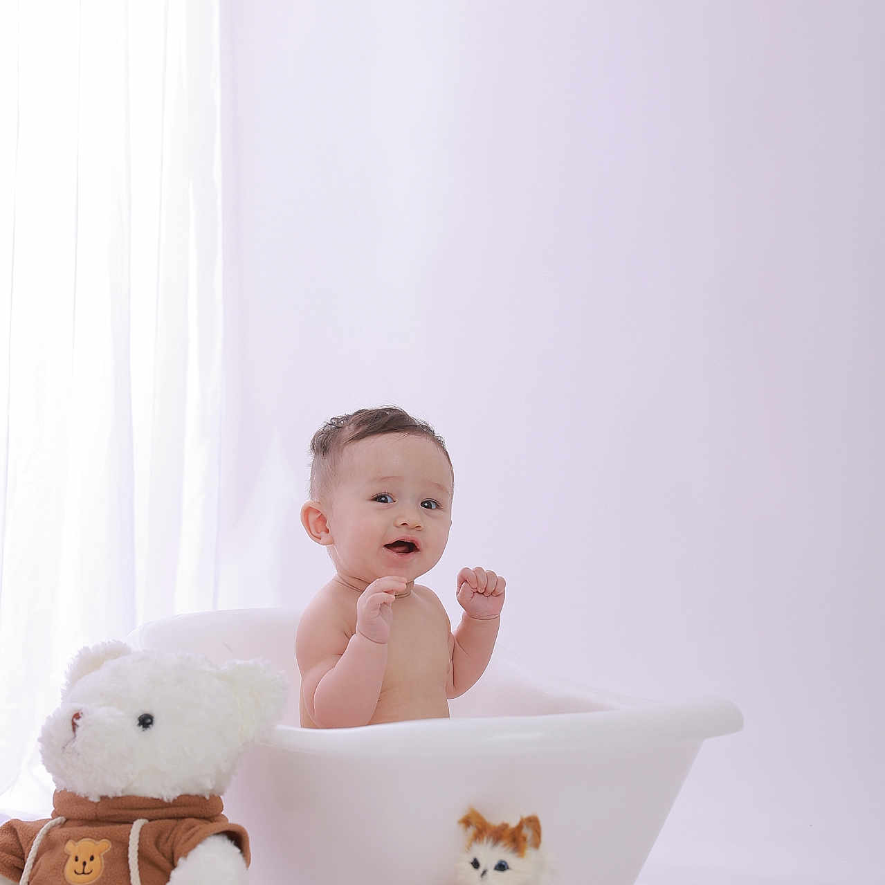 Maximillian joined the competition — help win amazing prizes! baby, child, infant, bathtub, teddy_bear, stuffed_animal, plush_kitten, portrait, indoors, nursery, pastel, white_background, soft_lighting, sitting, smiling, surprised, raised_hands, toy, cute, photography