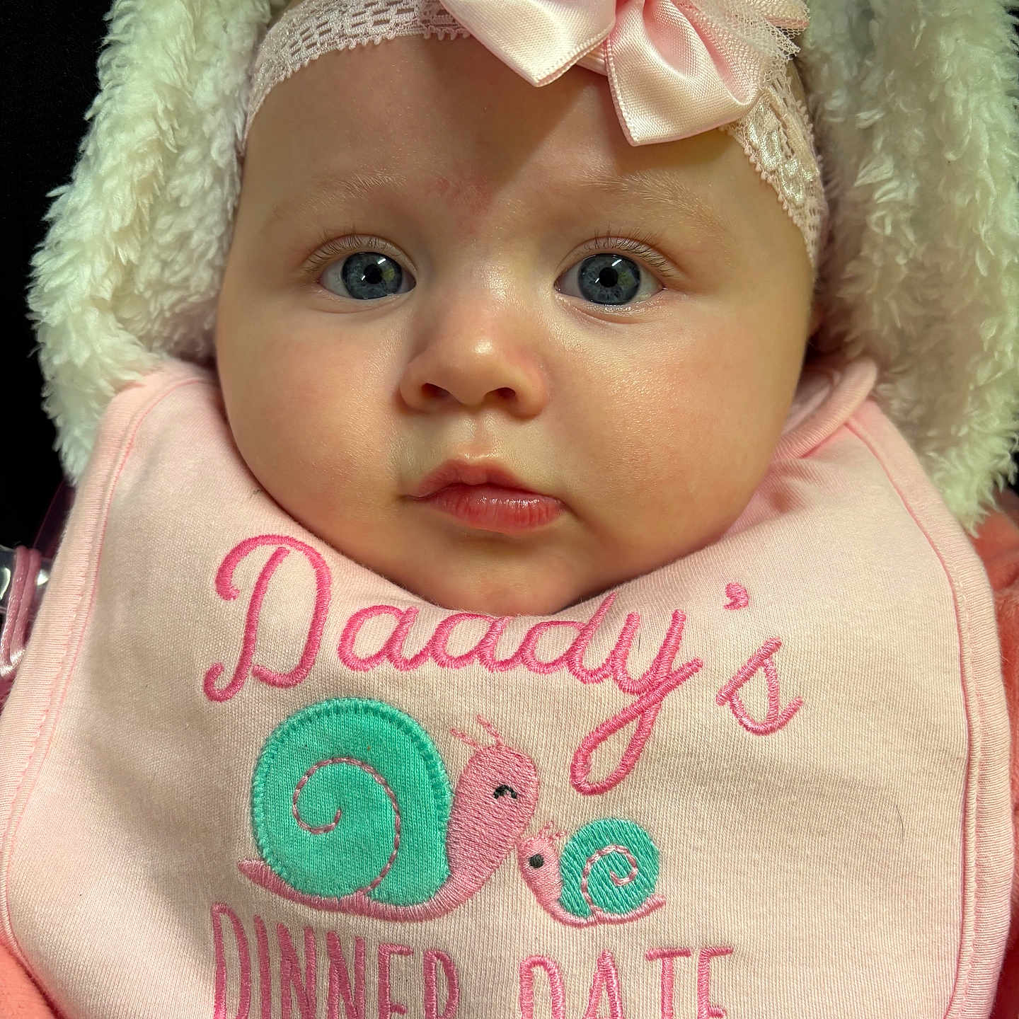 Silvia is registered to the contest to win money with this photo: adorable, baby, bib, blue_eyes, bow, child, closeup, clothing, cute, expression, face, fluffy, headband, infant, newborn, pink, portrait, snail, soft, warm