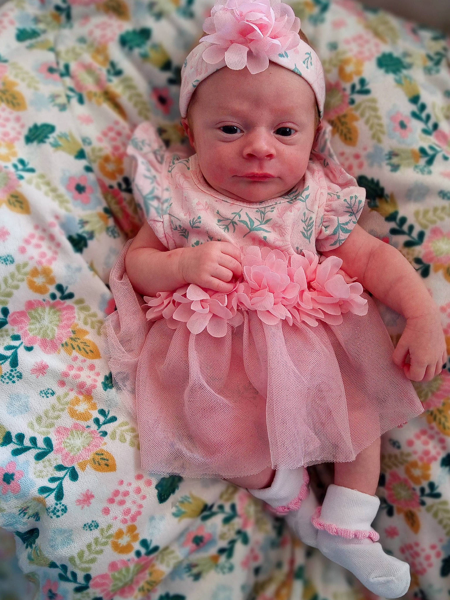 Emmy is registered to the contest to win money with this photo: baby, baby_toddler_clothing, cheek, child, dress, eye, face, happy, head, headgear, iris, linens, magenta, outerwear, pattern, person, pink, skin, sleeve, textile