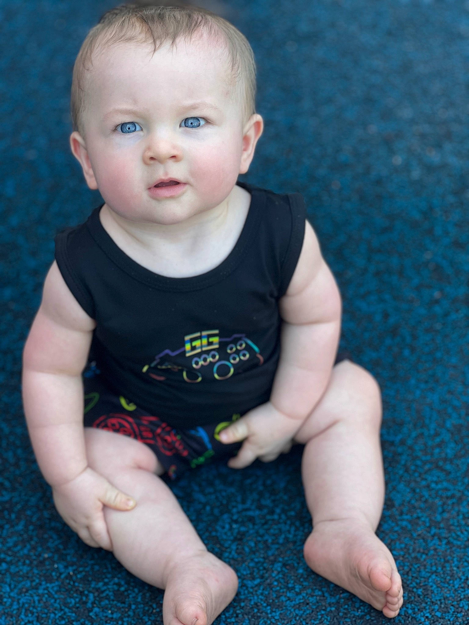 Chance is registered to the contest to win money with this photo: arm, azure, baby, baby_toddler_clothing, blue, cheek, child, chin, face, facial_expression, finger, flooring, grass, hairstyle, human_body, joint, leg, person, skin, sleeve