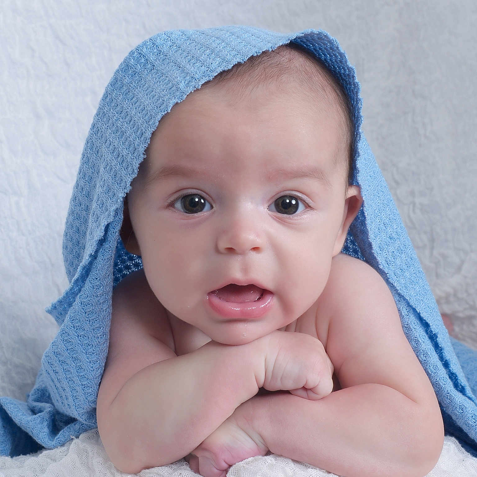 Andrew is registered to the contest to win money with this photo: baby, bodypart, bonnet, cap, clothing, face, finger, hand, happy, hat, head, hood, hoodie, newborn, person, photography, portrait, smile, sunhat, towel