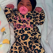 Nova is registered to the contest to win money with this photo: baby, bed, blanket, bonnet, cap, clothing, cushion, face, furniture, glove, hat, head, homedecor, newborn, person, photography, portrait, purple, quilt, sleeping