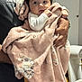 baby, child, blanket, pink_blanket, animal_print, infant, person, holding, hands, curious, wide_eyes, indoor, soft_texture, warm, clothing, adult, portrait, cute, newborn, family