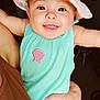 baby, child, smiling, tongue_out, hat, pastel_colors, turquoise_outfit, shell_patch, arm, hand, adult, holding, portrait, indoor, happy, cute, face, infant, closeup, skin