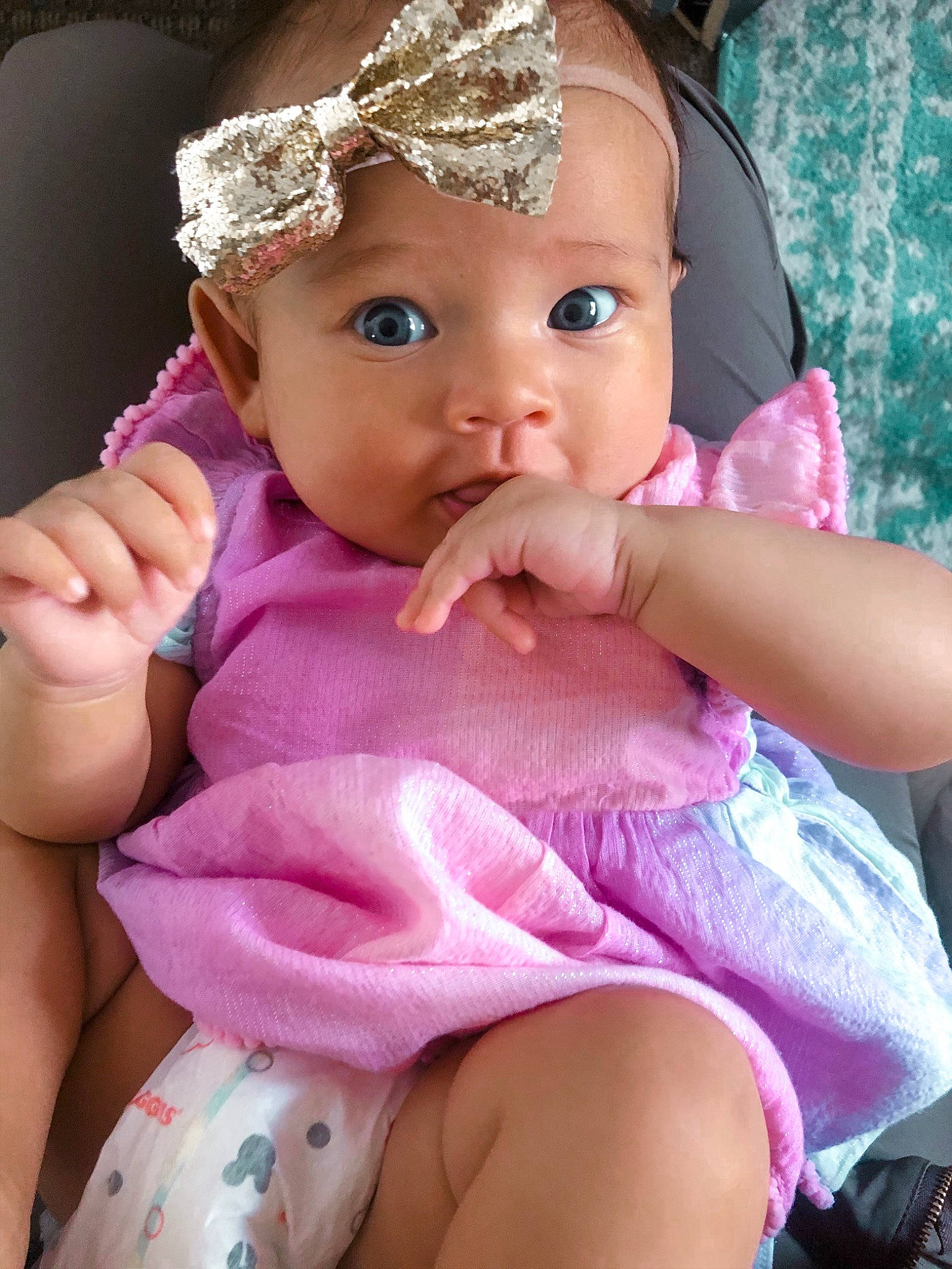 Ayva is registered to the contest to win money with this photo: baby, cheek, child, eye, eyelash, face, fashion_accessory, finger, hair_accessory, hand, head, headband, headgear, headwear, lip, mouth, nose, person, pink, skin