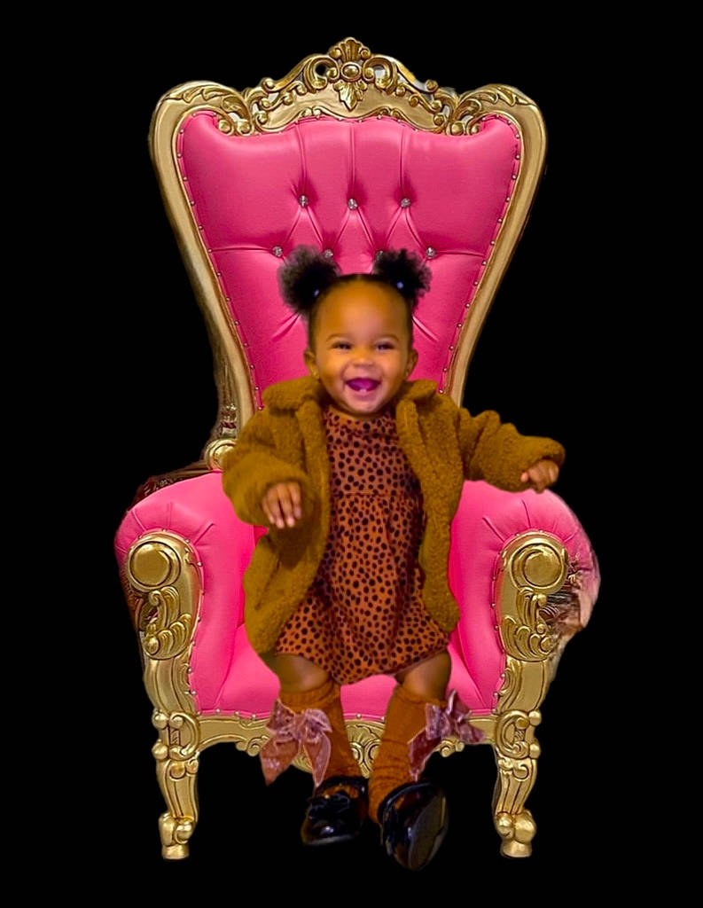 Ami is registered to the contest to win money with this photo: baby_products, baby_toddler_clothing, chair, child, costume, costume_hat, crown, event, fashion_accessory, fashion_design, fawn, fur, head, human_body, jewellery, joy, magenta, outerwear, peach, person