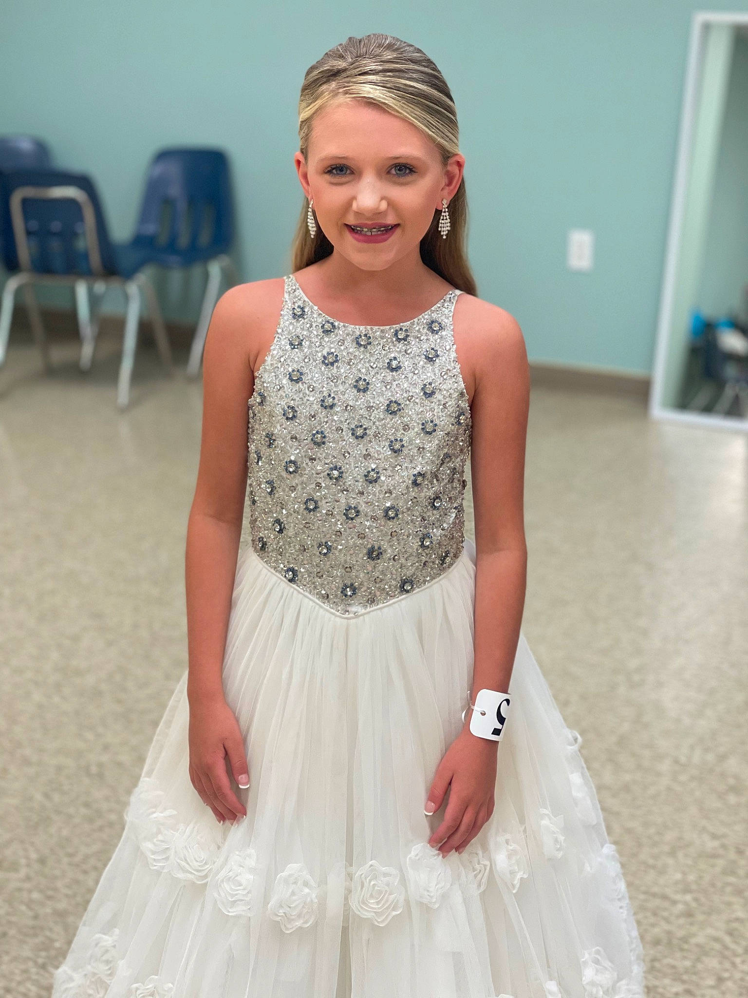 Harlee is registered to the contest to win money with this photo: bridal_accessory, chair, day_dress, dress, event, fashion_design, fashion_model, flooring, formal_wear, gown, happy, jewellery, joint, joy, neck, pattern, person, photograph, sleeve, smile