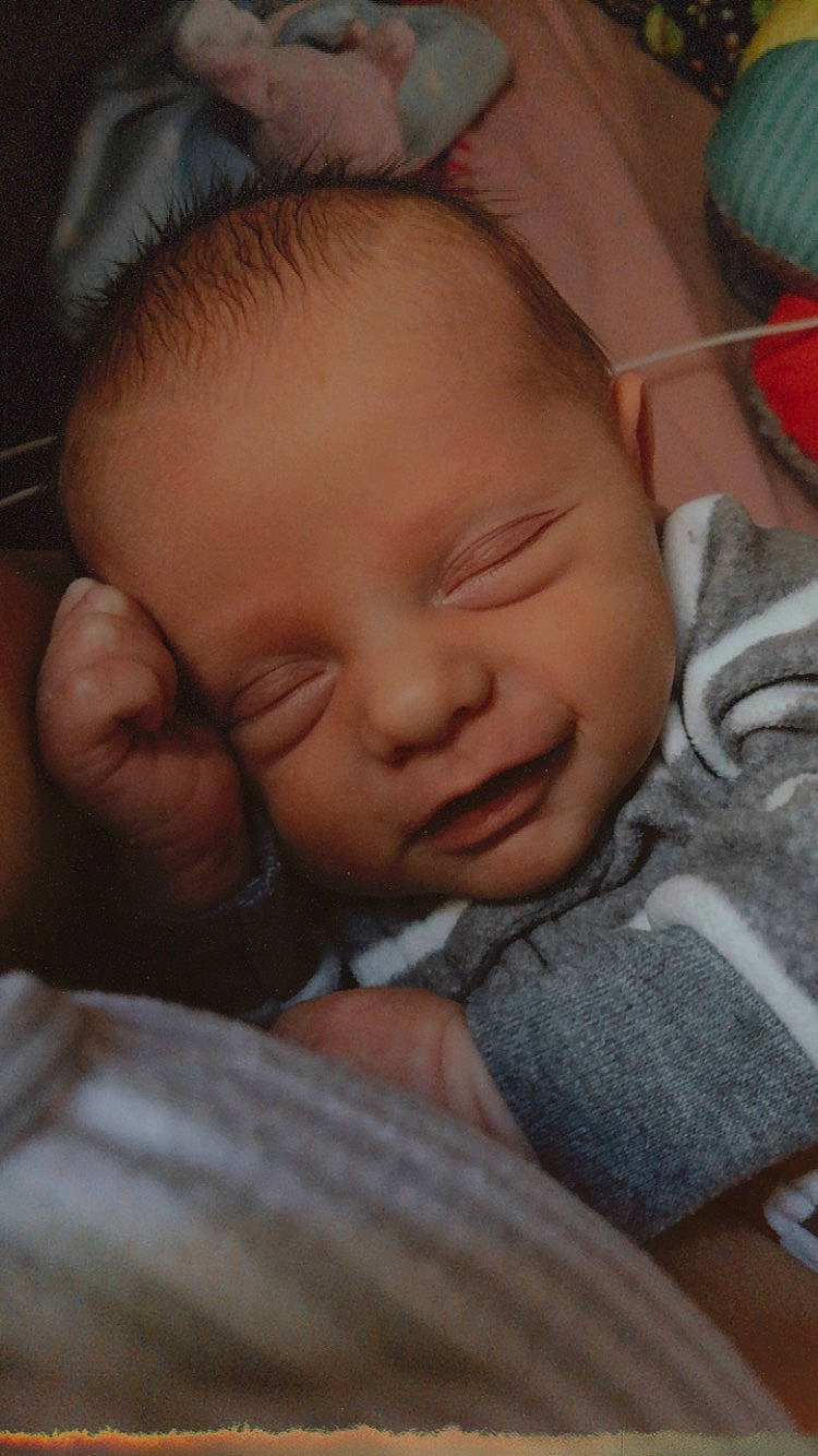 Jasper is registered to the contest to win money with this photo: baby, baby_toddler_clothing, cheek, chin, comfort, ear, eye, eyebrow, finger, forehead, gesture, hand, happy, iris, lip, mouth, nose, person, skin, smile