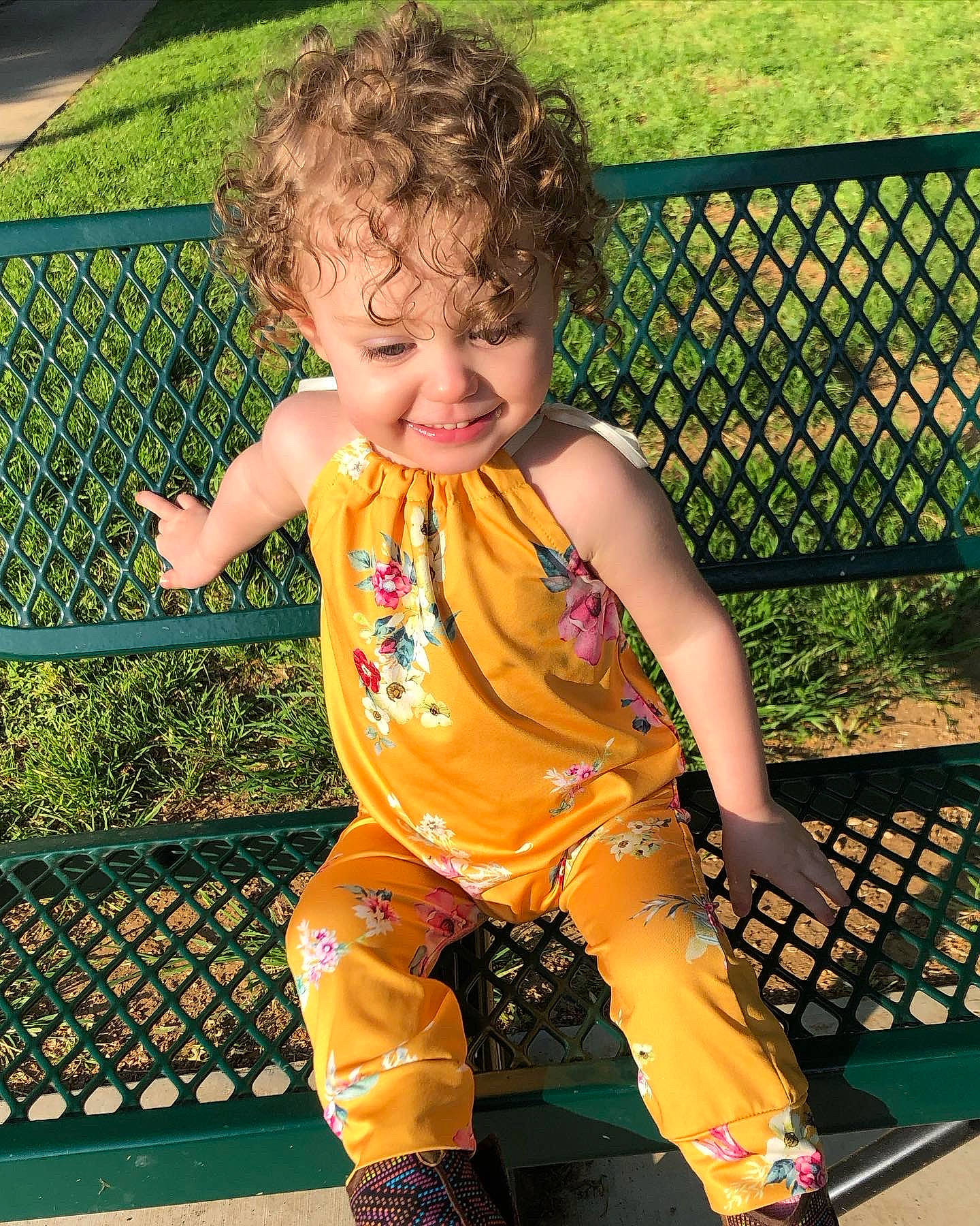 Haisley joined the competition — help win amazing prizes! baby_toddler_clothing, child, facial_expression, fence, fun, grass, green, hairstyle, happy, joy, leisure, mesh, outdoor_furniture, pattern, people_in_nature, person, recreation, sitting, sleeve, smile