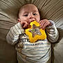 Jaxson joined the competition — help win amazing prizes! baby, infant, toy, yellow_star, striped_clothing, beatrix_potter, cushion, soft_fabric, hand, face, chewing, lying_down, cute, child, indoor, comfort, curious, young, portrait, cozy
