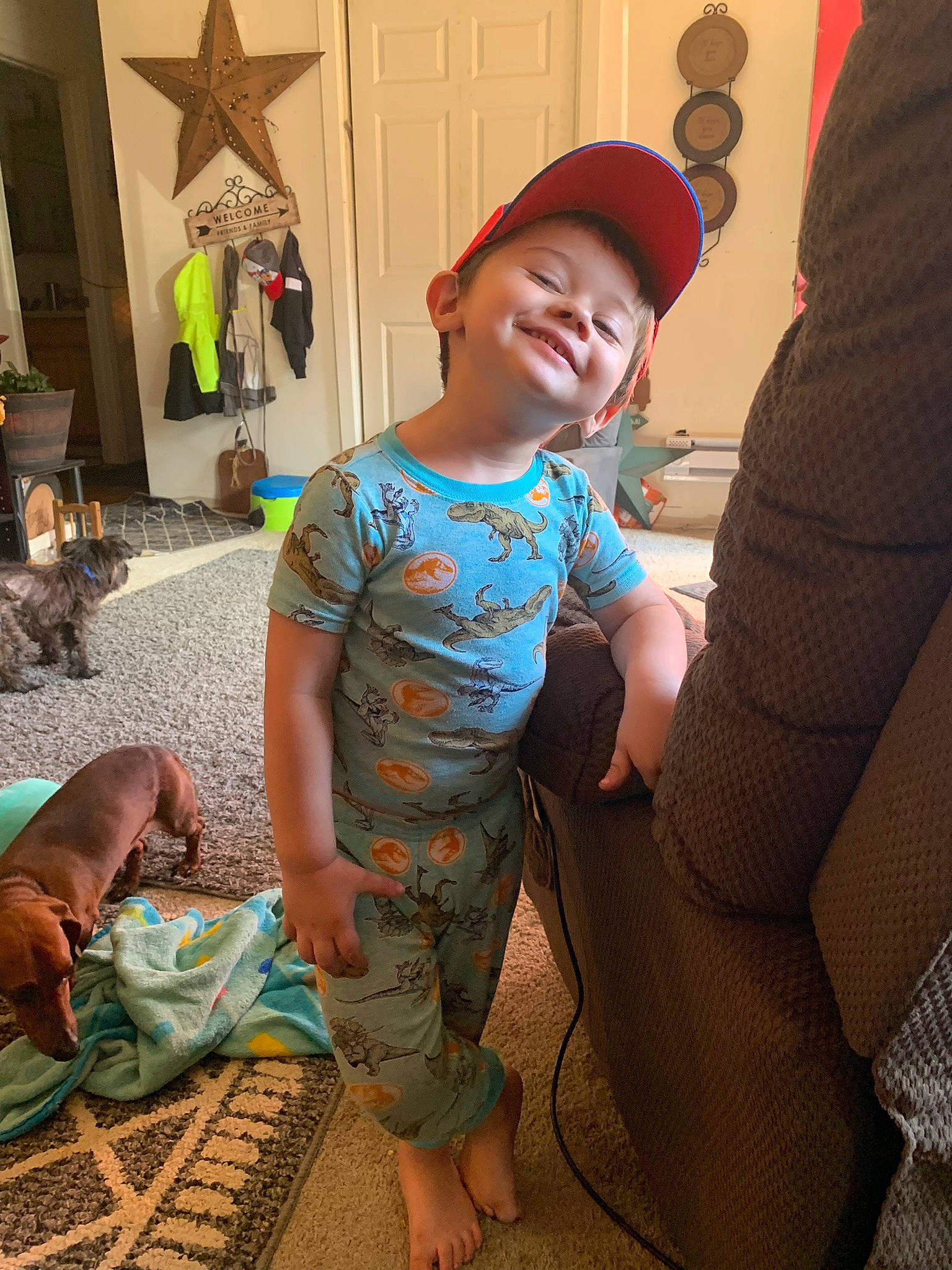 Brantley joined the competition — help win amazing prizes! barefoot, baseball_cap, cap, child, event, flooring, foot, fun, green, happy, human, human_leg, joy, leg, leisure, mammal, person, sitting, smile, t_shirt