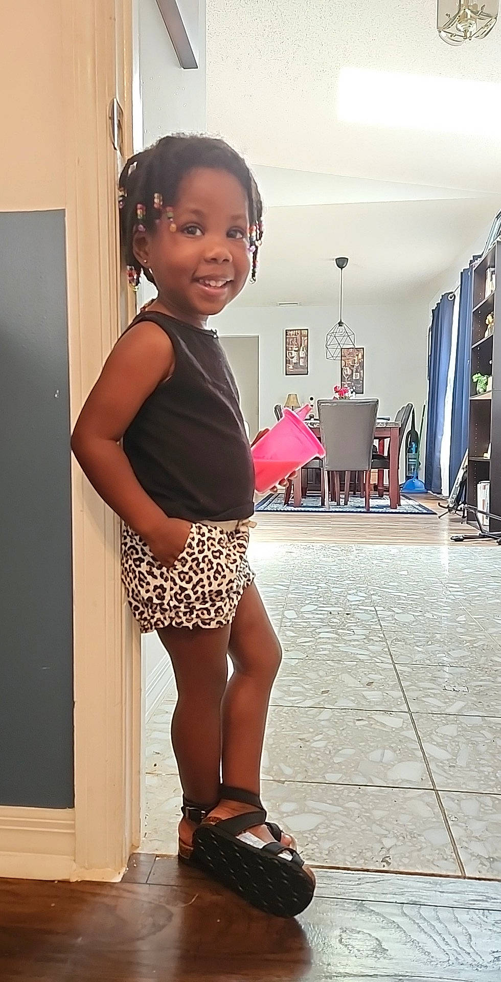 Zyana is registered to the contest to win money with this photo: calf, curtain, electric_blue, fashion_design, flooring, happy, human_leg, joint, joy, knee, magenta, pattern, person, sandal, shoulder, sleeve, smile, standing, thigh, toddler