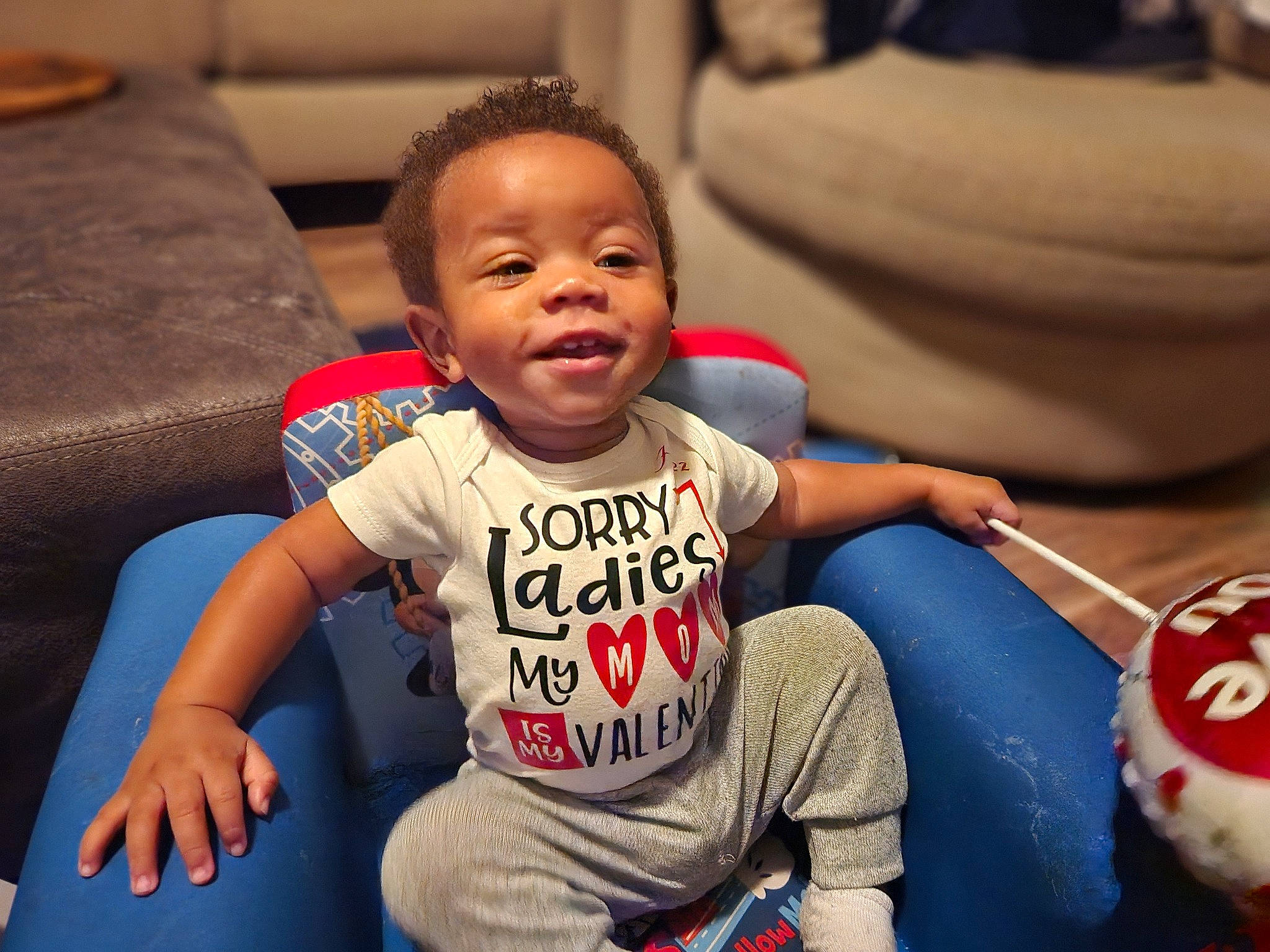 Hezekiah is registered to the contest to win money with this photo: baby, baby_toddler_clothing, cheek, child, comfort, eye, facial_expression, finger, fun, happy, head, human, leisure, mammal, mouth, person, skin, sleeve, smile, t_shirt