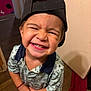 Miliano joined the competition — help win amazing prizes! child, toddler, smiling, face_paint, cap, shirt, barefoot, indoor, wooden_floor, happy, patterned_clothing, standing, cheeky, scribbles, playful, person, cute, expression, portrait, young_child