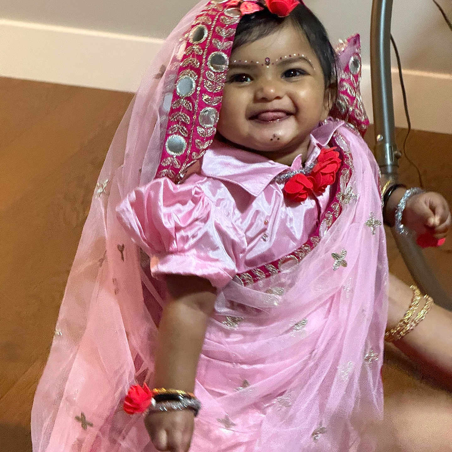 Divisha joined the competition — help win amazing prizes! baby, bracelets, celebration, child, cultural, cute, decorative, festive, floor, happy, headpiece, indoor, jewelry, person, pink_dress, portrait, smiling, toddler, traditional_clothing, young_child